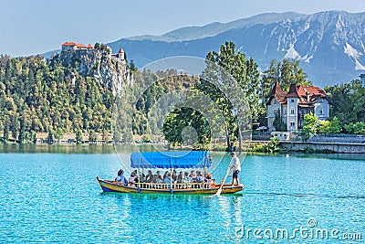 Castle and traditional wooden boat on Lake Bled, Slovenia Editorial Stock Photo